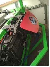 An image of a green machine in a garage.