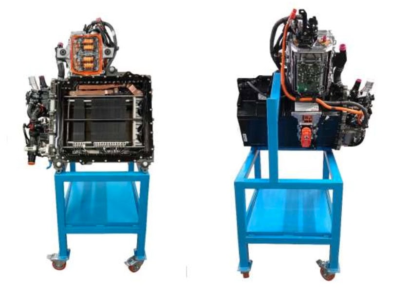 Two views of an electric vehicle powertrain system mounted on a blue metal stand, showing electronic components, wiring, and cooling systems.