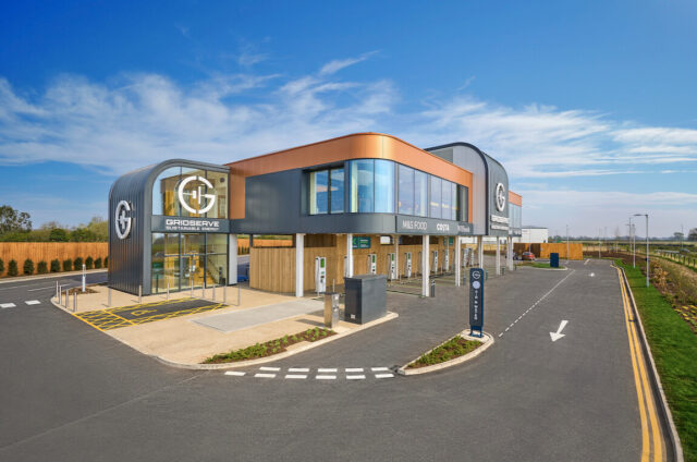 The exterior of a building with a parking lot in the background.
