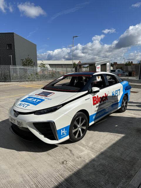 A toyota hybrid car parked in a parking lot.