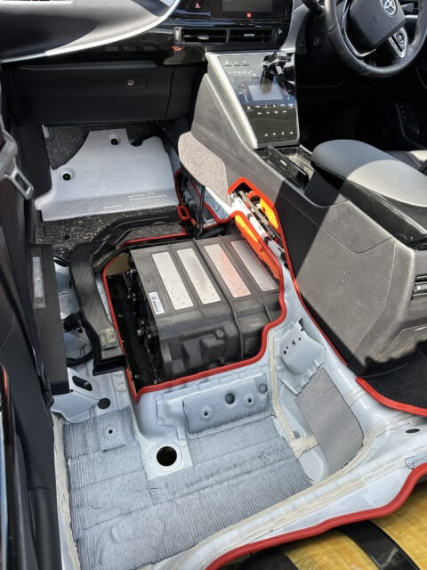 The interior of a car with a battery in it.