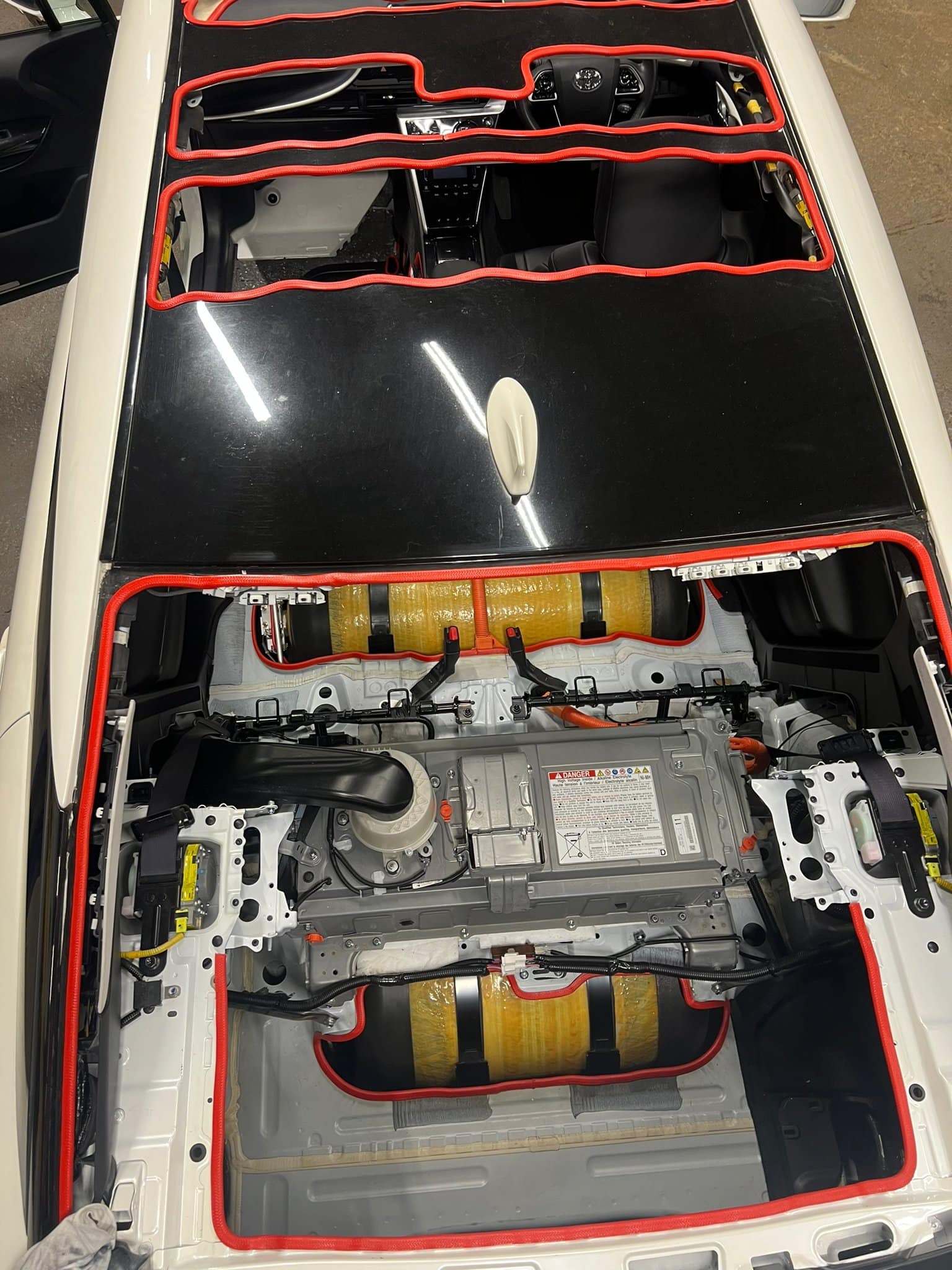 A car with a battery in the trunk.